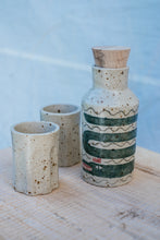 Load image into Gallery viewer, Yr hyn a gwymp, nid yw'n orffenedig: Potel Rym a Biceri / What Falls Is Not Finished: Rum bottle and Beakers
